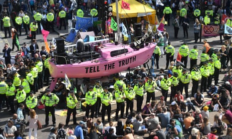 Police officers surround a protest boat at Oxford Circus