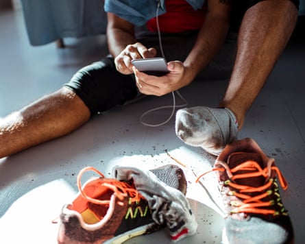 Close up of a man getting his dirty shoes off after a workout