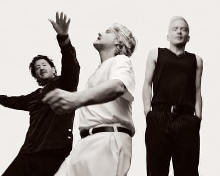 black and white photo of three men dancing