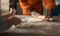 A woman and child's hands make pizza dough from scratch