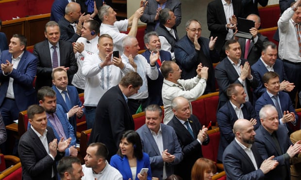 Lawmakers clap and smile in Ukraine's parliament