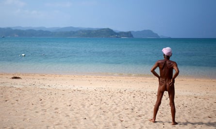 The naked hermit, Masafumi Nagasaki, staring at the sea.