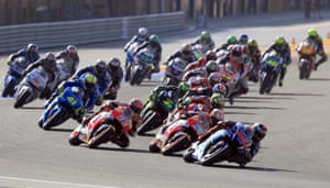 Jorge Lorenzo leads into a corner as Valentino Rossi (second right) attempts to scythe through the field.