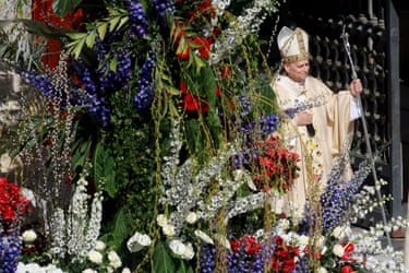 The pope next to a flower display
