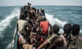 A small boat full of people at sea.