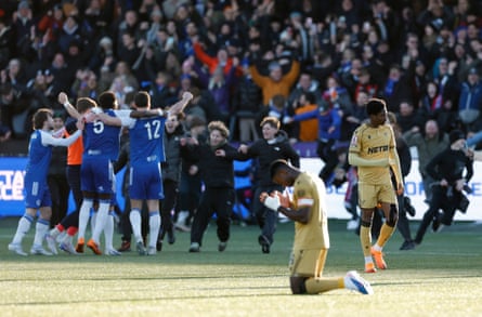 Marc Guéhi is on his knees as Macclesfield celebrate their victory against Crystal Palace.