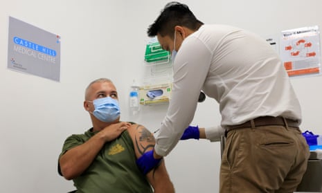 man receives covid vaccine in a doctor's surgery