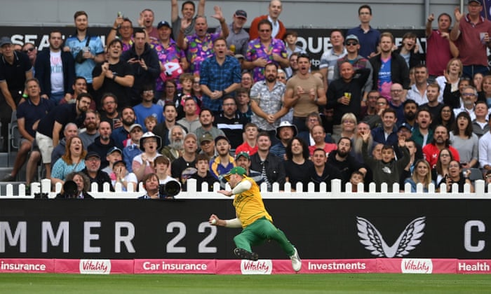 The crowd gasps as England batsmen Jos Buttler is caught by fielder David Miller on the boundary.