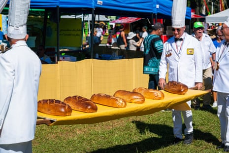 Loaves of bread are carried in the parade ready to be carved into smaller pieces and served with the omelette.