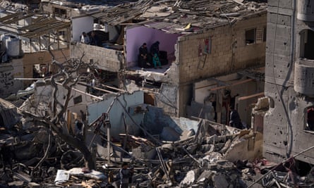 Palestinians look at the destruction after an Israeli strike on residential buildings and a mosque in Rafah, Gaza Strip, Thursday, Feb. 22, 2024. (AP Photo/Fatima Shbair)