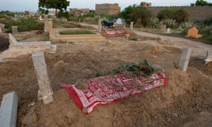 The graves of Ghani Rehman, 17, and Bakhtaja, 15, in Ali Brohi Goth, Karachi