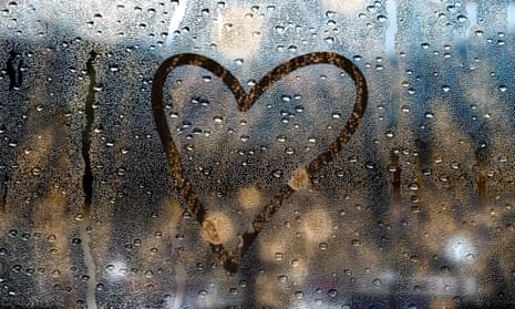 Heart drawn on a window wet from the rain