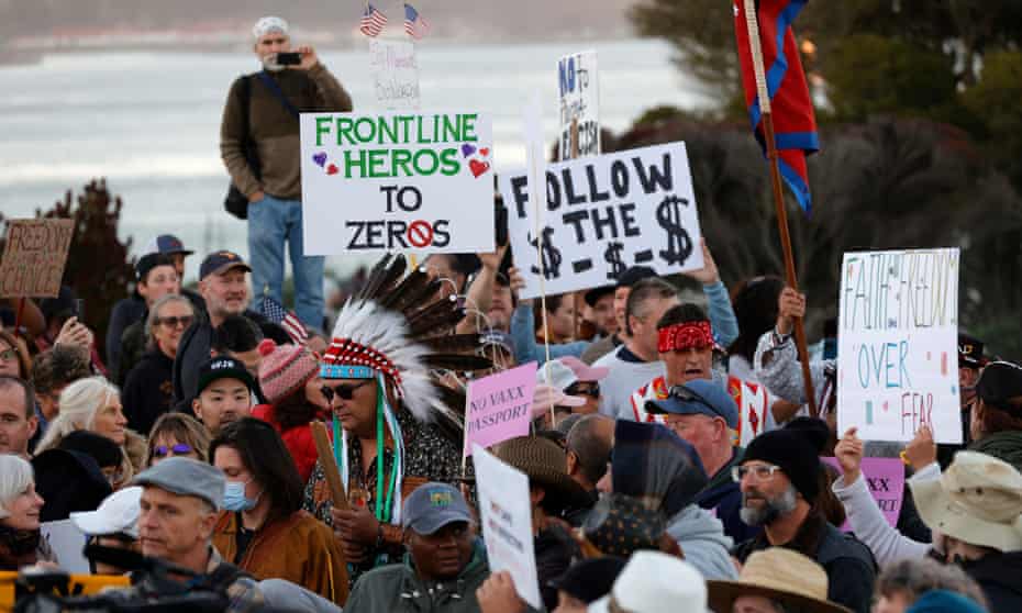 Protesters hold signs during an anti-vaccination rally at the Golden Gate Bridge in San Francisco, California.