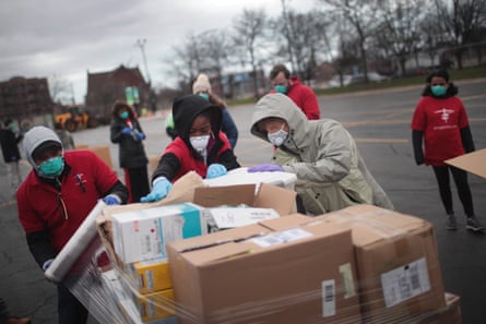Staff and volunteers with Project C.U.R.E hold a drive outside the United Center to collect donations of personal protective equipment from the community to be used to supply hospitals and clinics that are experiencing shortages due to the Covid-19 pandemic in March in Chicago, Illinois.