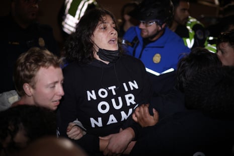 Members of U.S. Capitol Police try to push protester away from the headquarters of the Democratic National Committee during a demonstration against the war between Israel and Hamas on November 15, 2023 on Capitol Hill in Washington, DC.