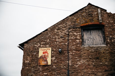 Stone-built outbuilding with Eggs for Sale sign showing picture of a hen