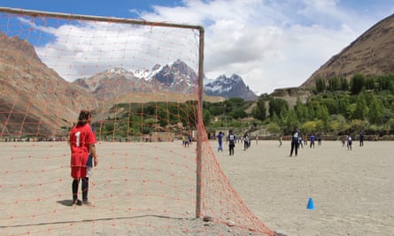 Girls play football on a dusty pitch in Shimshal.