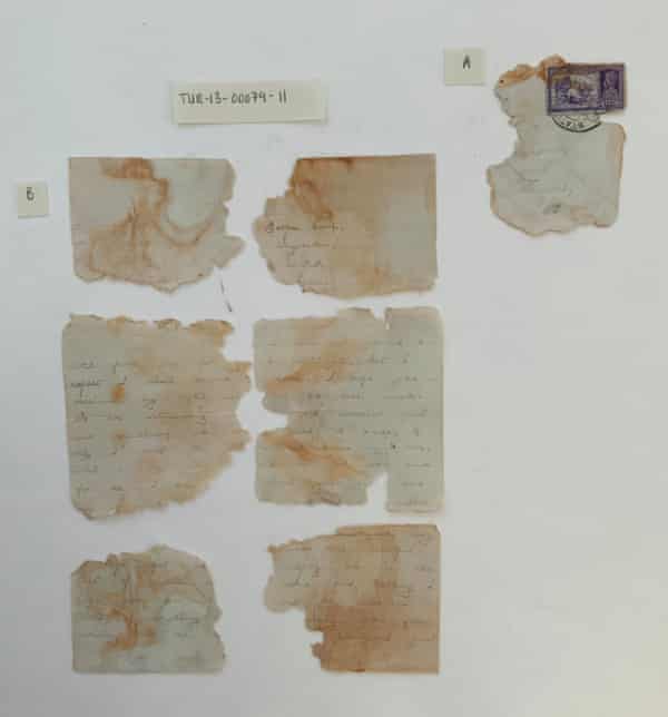 Fragments of the love letter and accompanying envelope fragment featuring a stamp and postmark.