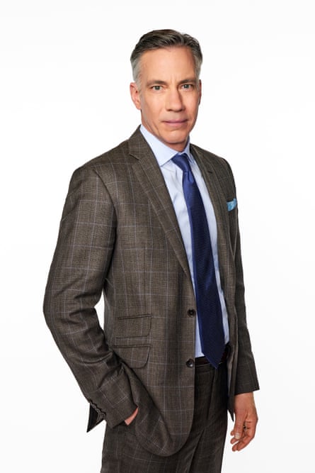 Man wearing plaid suit and blue tie