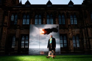 Uili Lousi, a Tongan activist, stands alongside Flare Oceania 2021, a work created by the artist John Gerrard, at the University of Glasgow