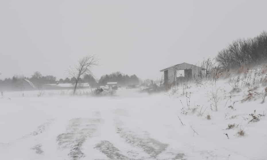 Snow covers farm buildings on a Minnesota dairy farm