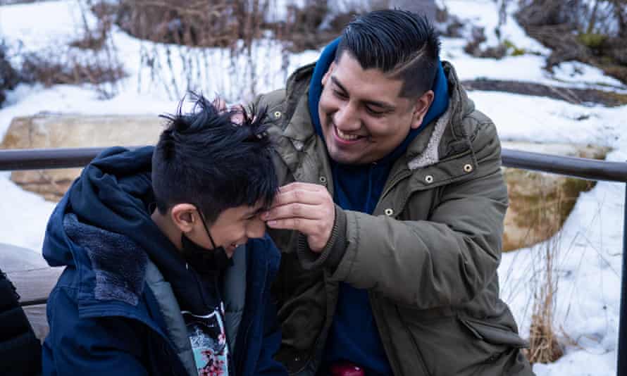 Benitez plays with his son at the park.