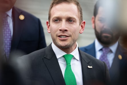 a man in a suit and green tie