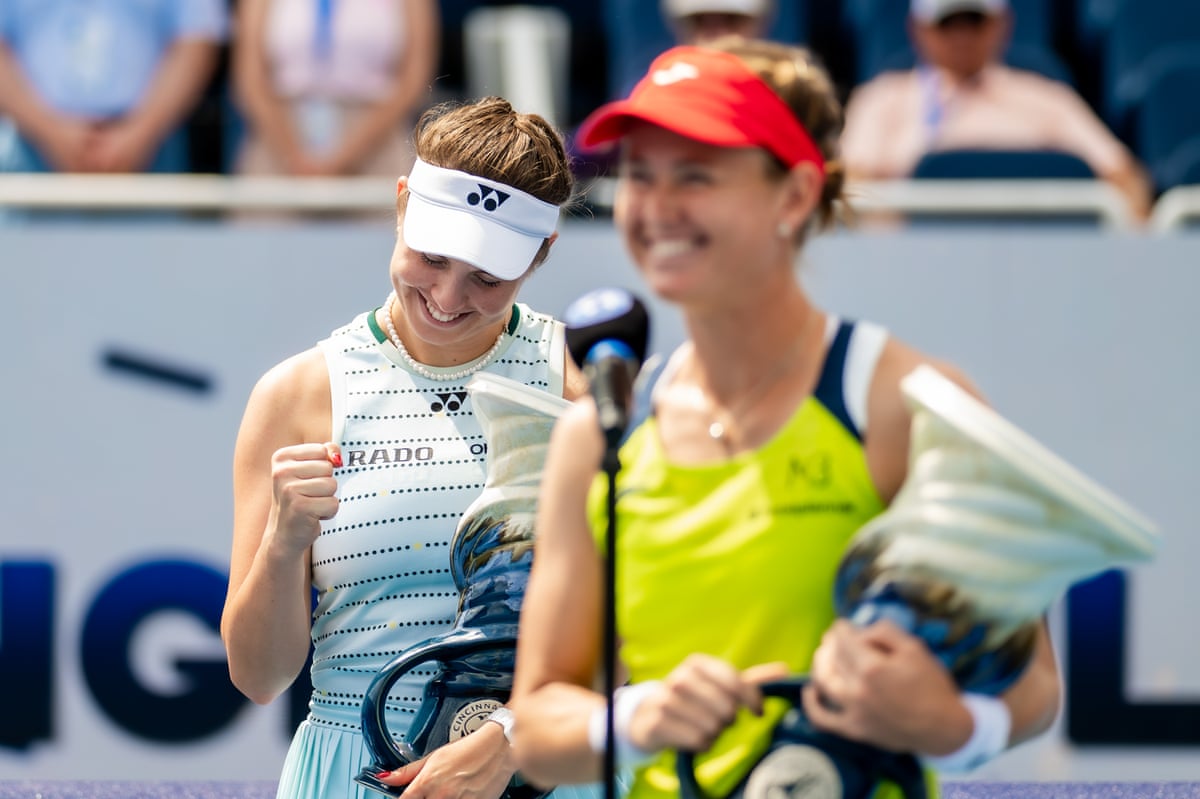 Linda Noskova clenches a fist in celebration as Marie Bouzkova is interviewed after their doubles win in Cincinatti