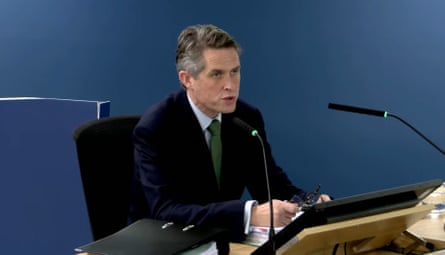 Gavin Williamson sat at a table talking into a microphone