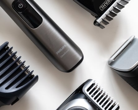View of five beard trimmers lying on a flat surface.