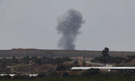 Smoke rises after an airstrike in Gaza, as seen from Israel, 25 April.