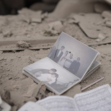 A photo album on dust and debris-covered floor.