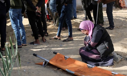 A woman grieves as people bury the bodies of Palestinians killed in Khan Younis.