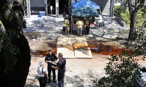 Police officers talk to an employee at the Rehabilitation Center at Hollywood Hills in Hollywood, Florida, where eight residents died in Hurricane Irma’s aftermath, authorities said Wednesday.