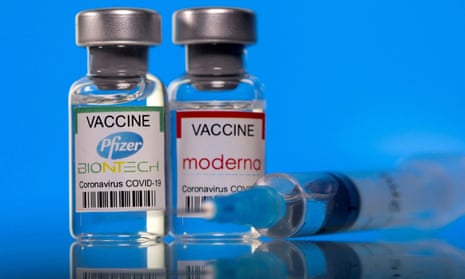 Vials with Pfizer-BioNTech and Moderna coronavirus vaccine labels.
