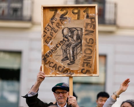 A man holds up a placard