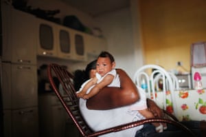 Three-month-old Alice Vitoria, who has microcephaly, is held by her mother Nadja Cristina at their home in Recife, Brazil