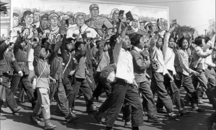 Red Guards and students, waving copies of Mao’s Little Red Book, parade in Beijing at the beginning of the Cultural Revolution.