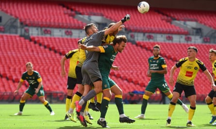 James Belshaw punches the ball clear during the National League playoff final against Notts County.