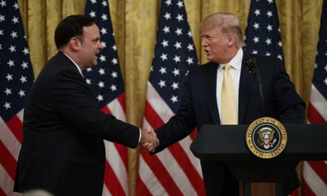 Donald Trump shakes hands with White House social media director Dan Scavino during a social media summit at the White House.