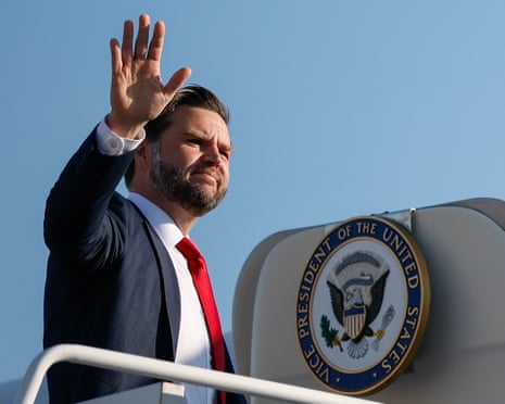 JD Vance waves as he boards a plane
