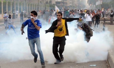 Supporters of Mohamed Morsi run from tear gas during clashes with riot police close to Rabaa al-Adawiya square in November 2013.