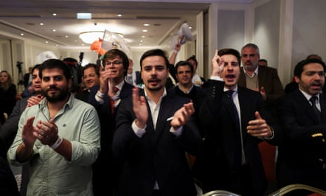 Supporters of far right Chega party react to the first exit polls during the general election in Lisbon.