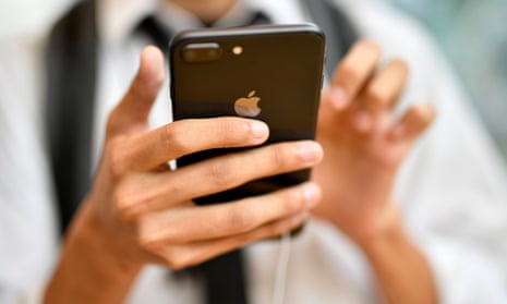 A young man looks at Apple's new iPhone 8 Plus at the Apple Store of Omotesando shopping district in Tokyo, Japan, 2017.