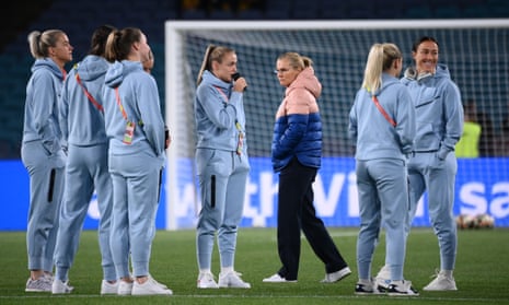 England’s coach Sarina Wiegman and some of her players check out the pitch before warmups.