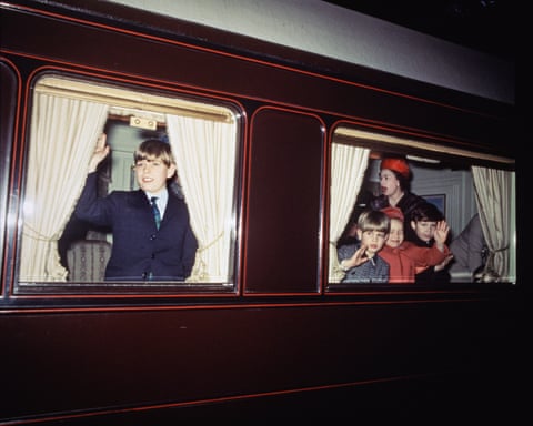 Members of the royal family at two windows of the royal train