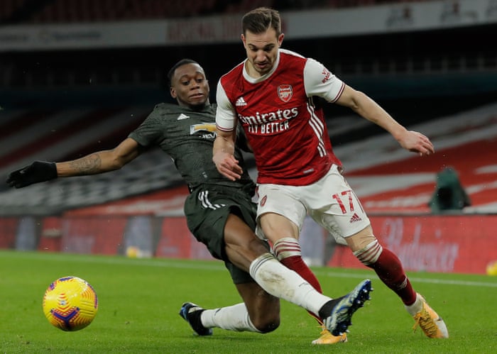 Cedric Soares of Arsenal is fouled by Aaron Wan-Bissaka of Manchester United.