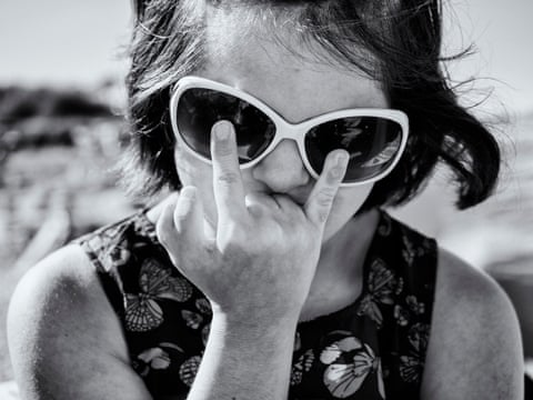 On the beach Maria clowns with her family exhibiting her unique six fingers giving the Makaton sign language of love, 2026. All photos by Carol Allen-Storey
