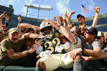 Packers running back MarShawn Lloyd celebrates a rushing touchdown with fans at Lambeau Field during SundayâÂÂs 31-7 victory over the Bears in Green Bay, Wisconsin.