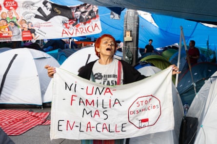A woman holds up a banner